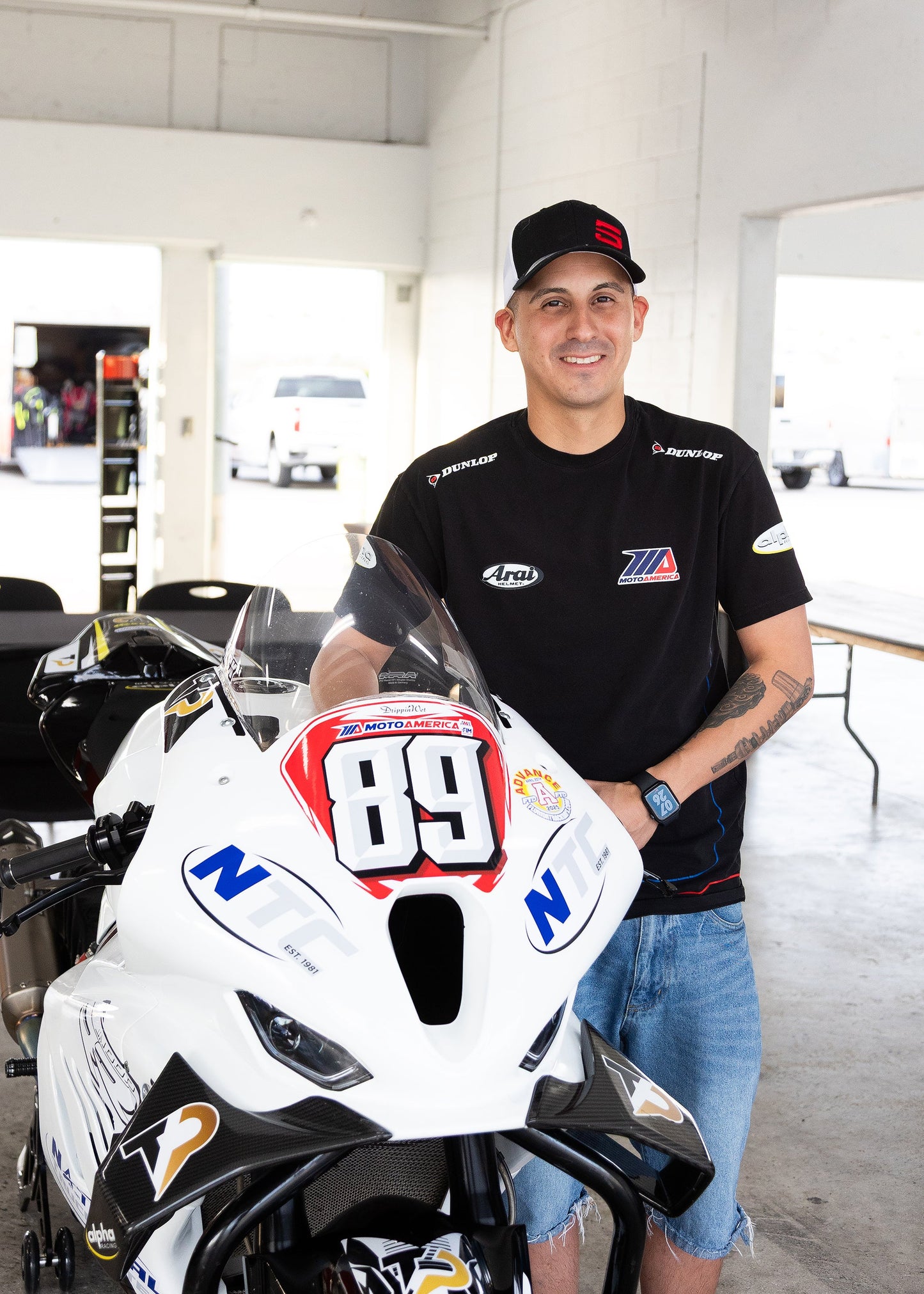 Motorcycle technician mounting a high-performance tire on a sport bike at Top Pro Motorsports in Coral Springs.