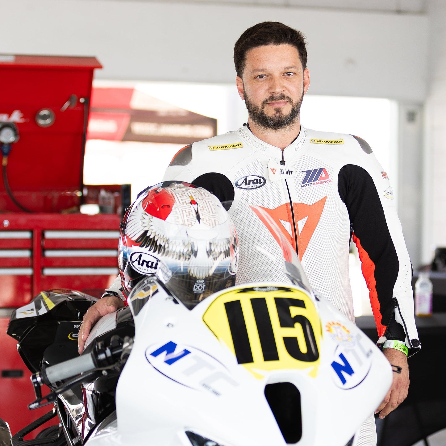 Motorcycle rider in full track gear prepares for a South Florida track day with gear from Top Pro Motorsports