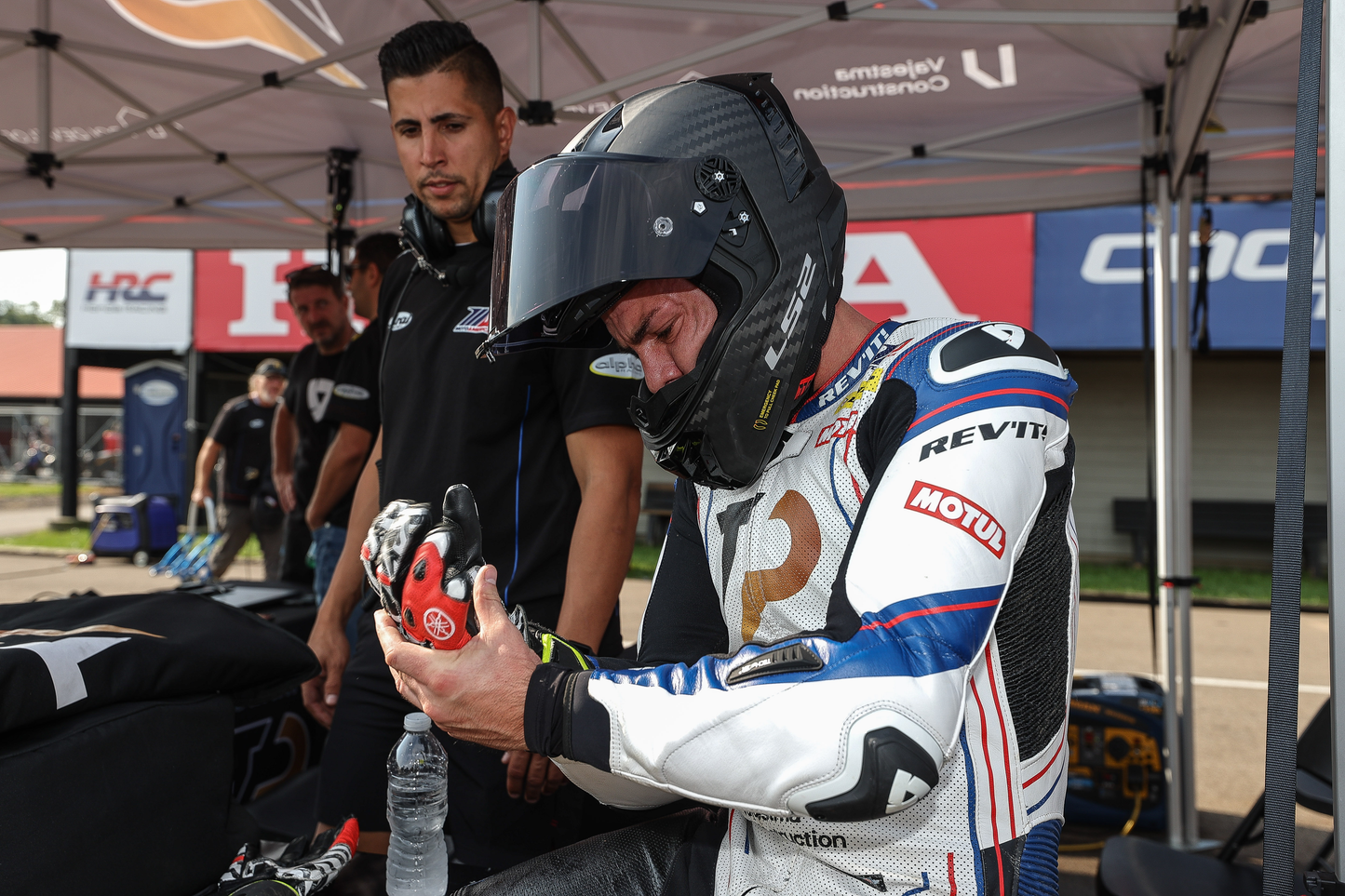 Mechanic at Top Pro Motorsports inspecting a sport bike tire in Coral Springs, Florida