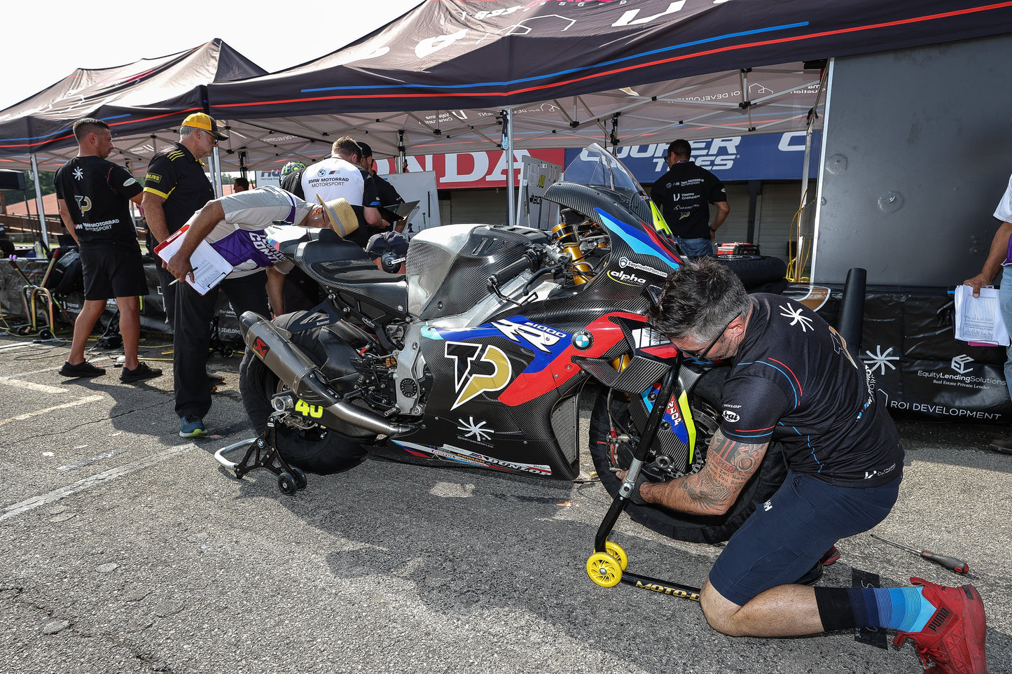 Photo showing a range of premium motorcycle helmets, gloves, and racing suits displayed inside Top Pro Motorsports’ Coral Springs store, highlighting the variety of high-quality gear available for South Florida riders