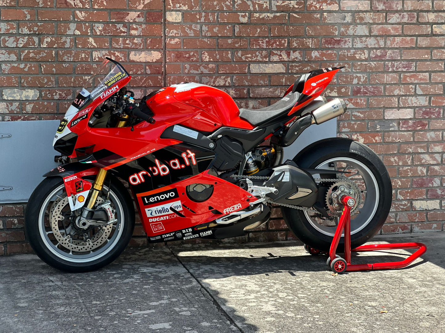 Rider preparing a motorcycle for the track with Top Pro Motorsports