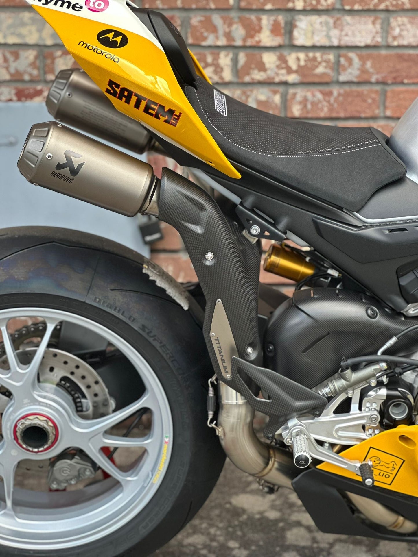 Motorcycle exhaust pipe with visible flames from popping