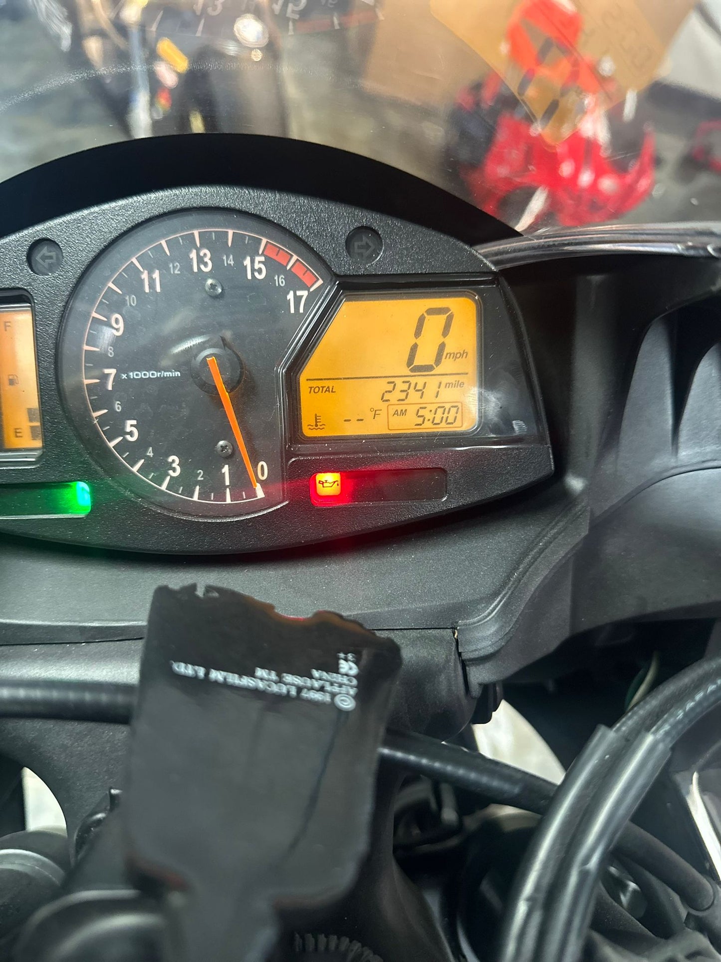 Motorcycle mechanic in Coconut Creek performing maintenance on a custom sportbike at Top Pro Motorsports, with tools and diagnostic equipment visible.