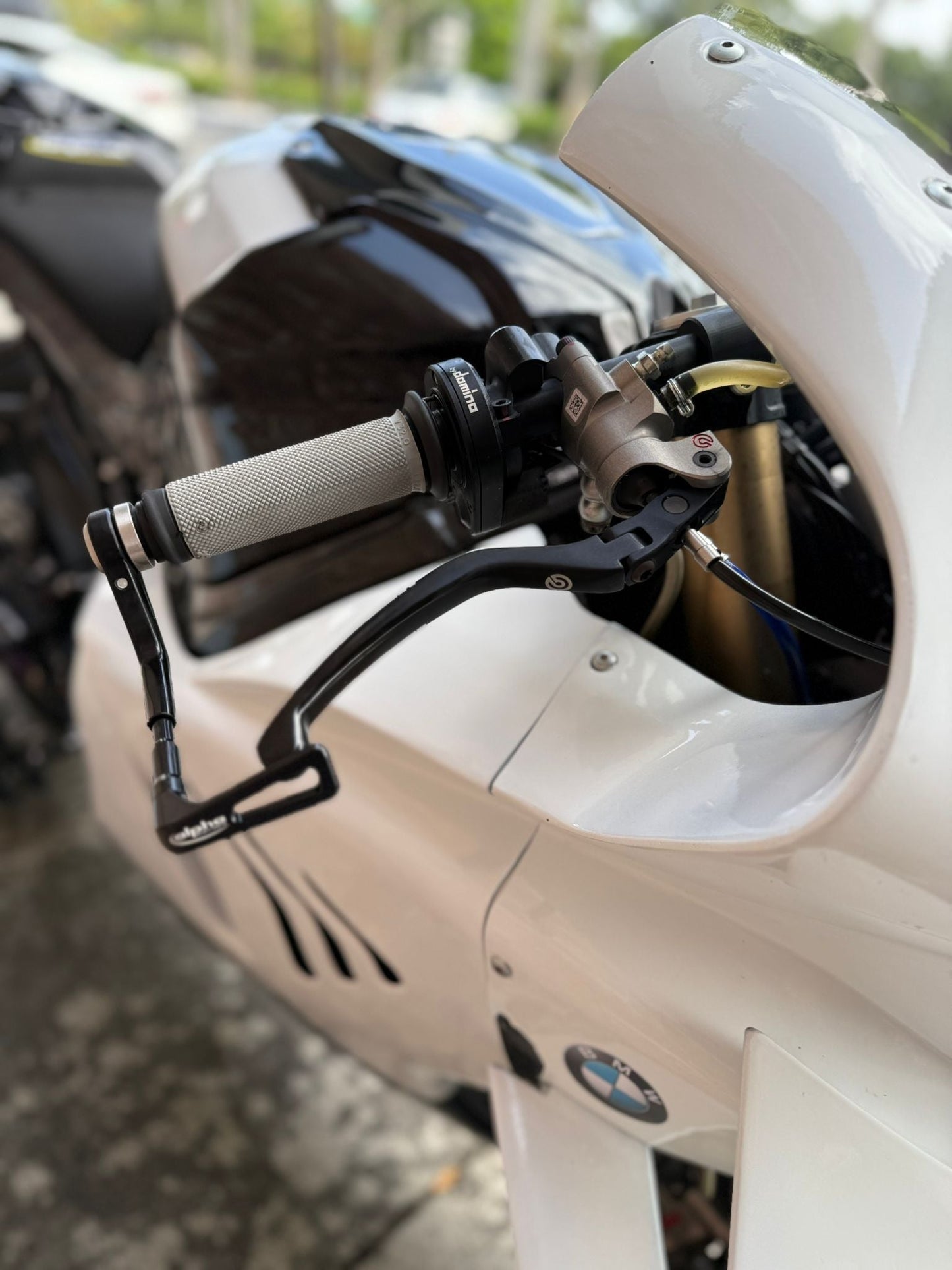 Motorcycle rider adjusting helmet before South Florida track day”