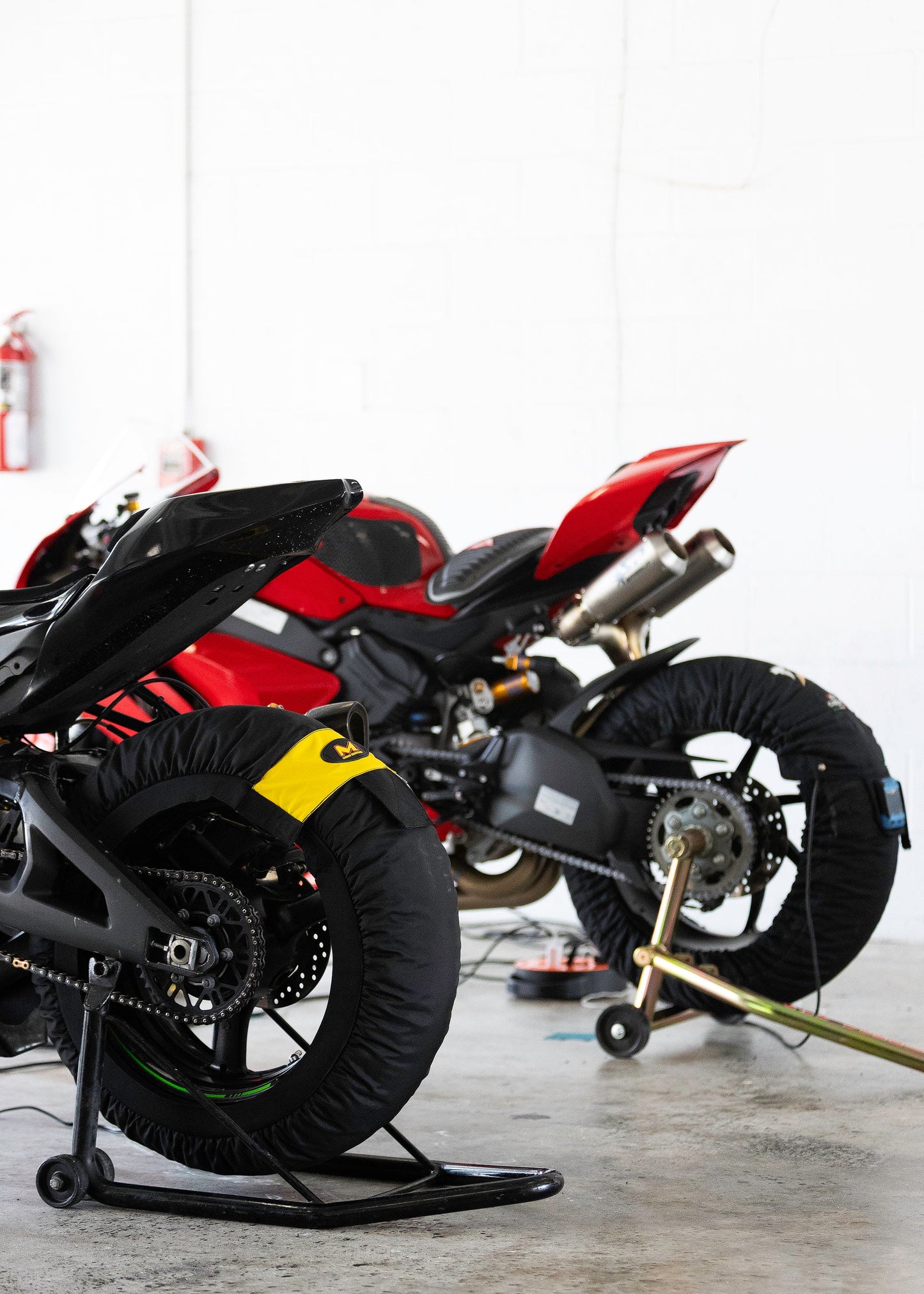 Motorcycle mechanic inspecting engine parts at Coral Springs garage.