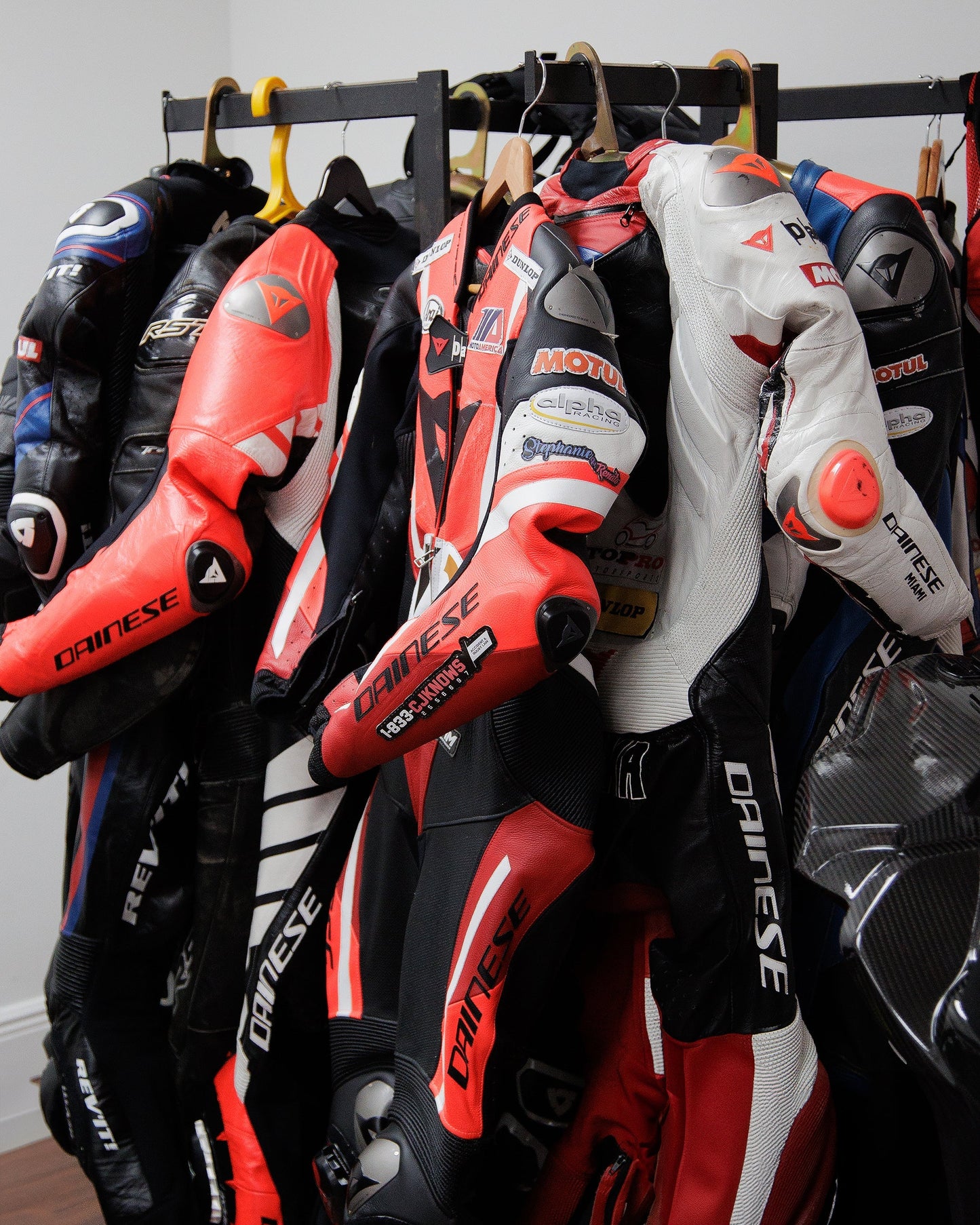 A display of motorcycle gear in-store: helmets, jackets, gloves, and boots on shelves and mannequins.