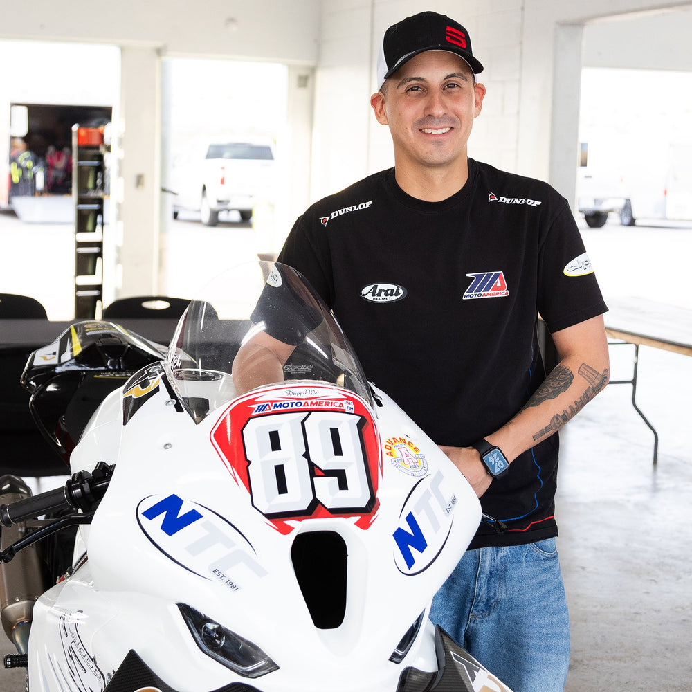 Motorcycle technician mounting a high-performance tire on a sport bike at Top Pro Motorsports in Coral Springs.
