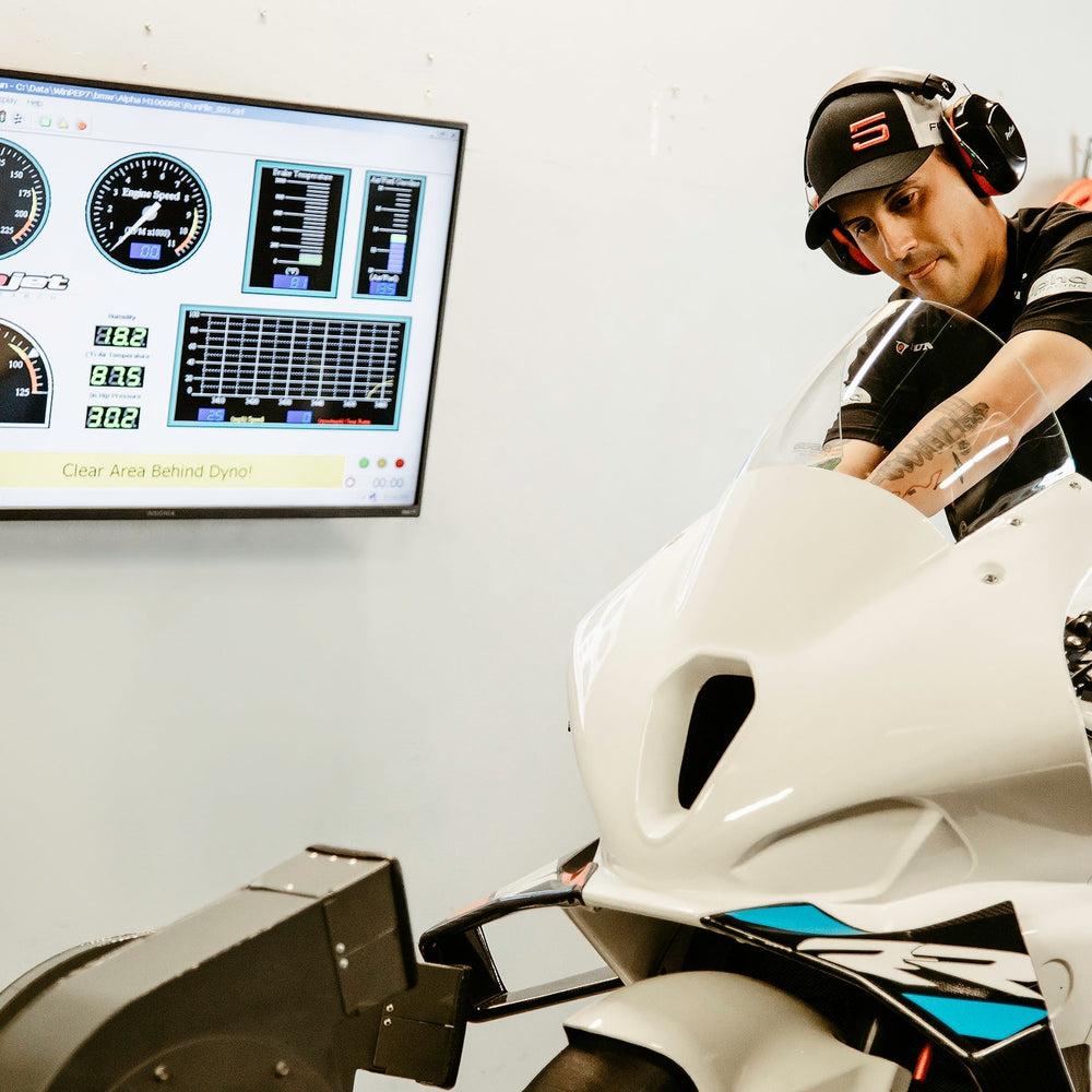 Motorcycle on a dynamometer being tuned at Top Pro Motorsports in Coral Springs for optimal performance
