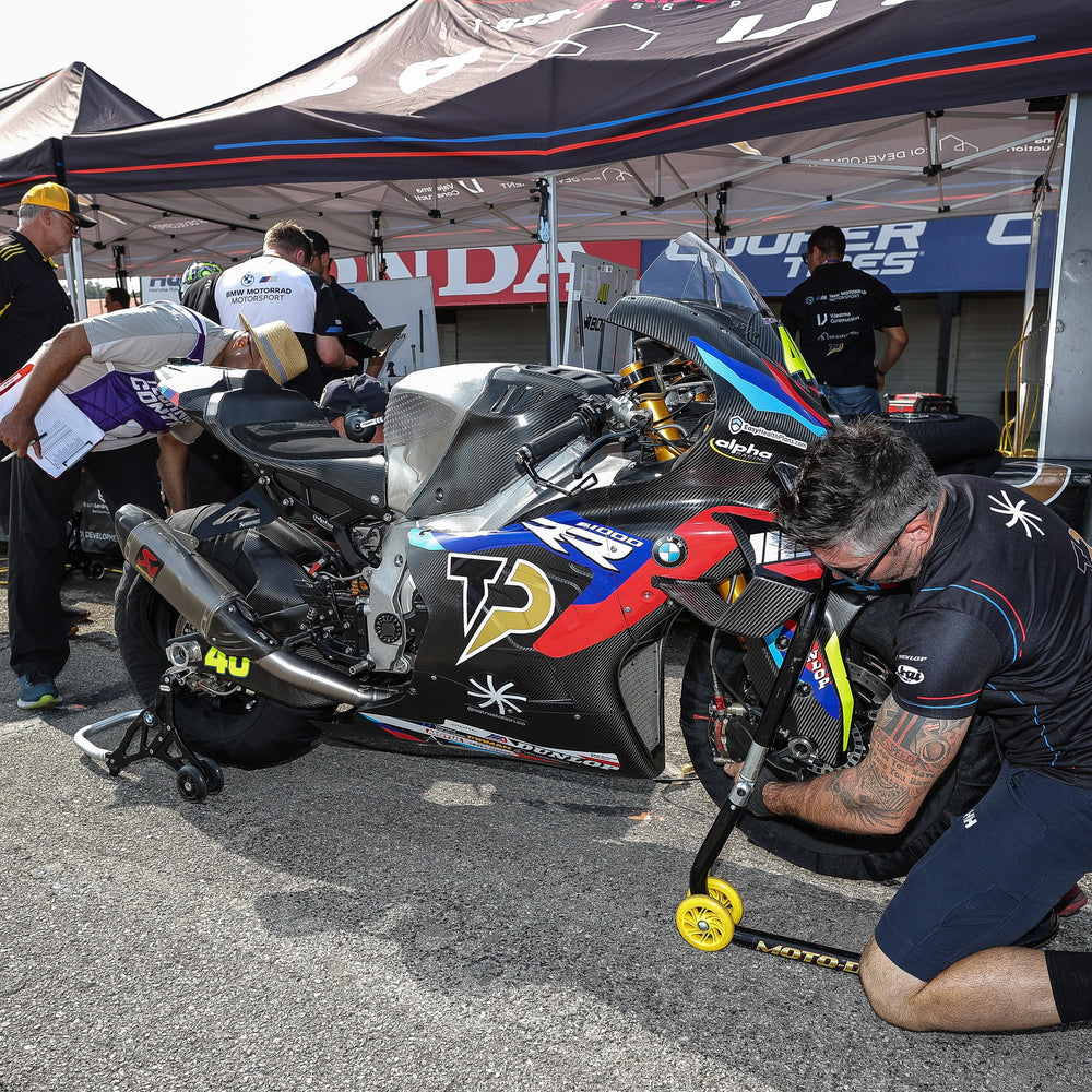 Photo showing a range of premium motorcycle helmets, gloves, and racing suits displayed inside Top Pro Motorsports’ Coral Springs store, highlighting the variety of high-quality gear available for South Florida riders