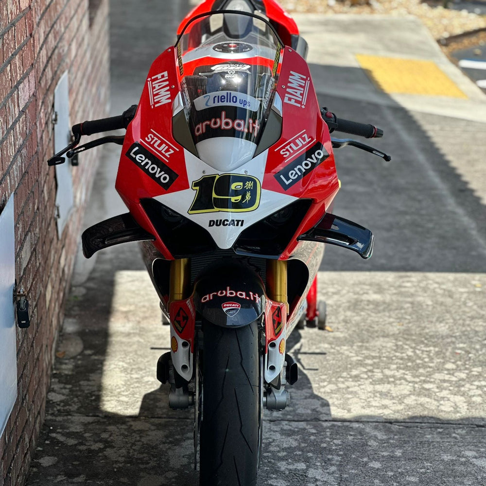 Yamaha R6 with aftermarket exhaust in Florida garage