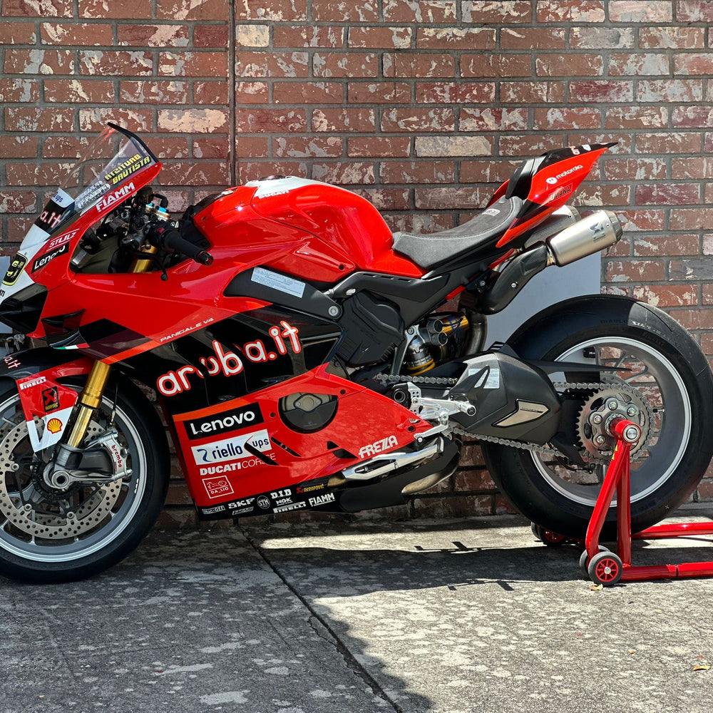Rider preparing a motorcycle for the track with Top Pro Motorsports