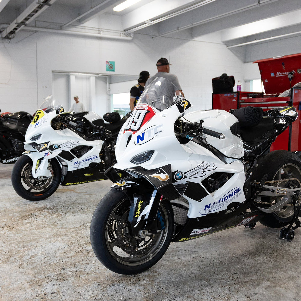 Motorcycle maintenance technician checking tire pressure in Coconut Creek.