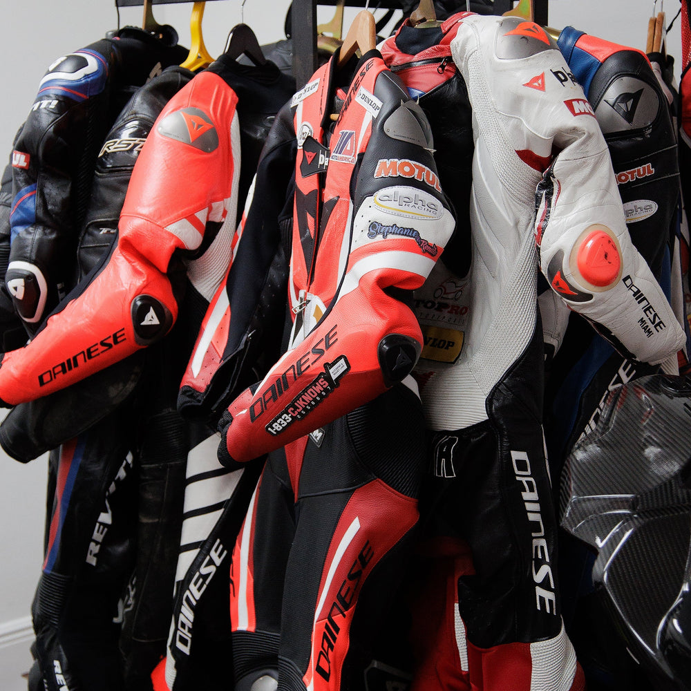 A display of motorcycle gear in-store: helmets, jackets, gloves, and boots on shelves and mannequins.