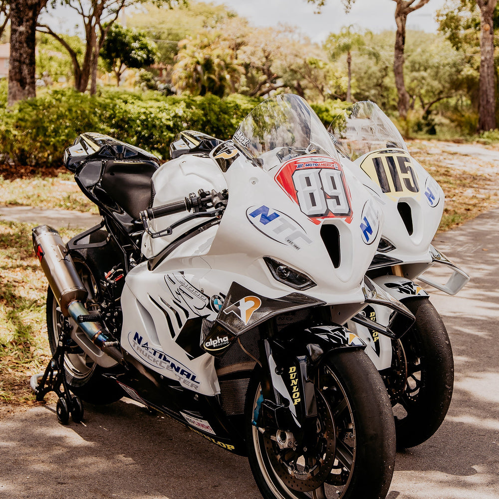 A group of riders on sport bikes gathering in the parking lot before a South Florida group ride.